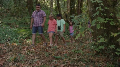 Children explore nature on a summer hike at a fun outdoor camp adventure