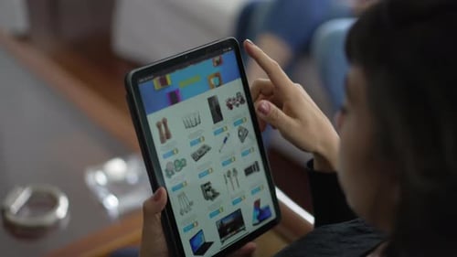 Closeup of hands holding tablet shopping online store website. Person browsing household products