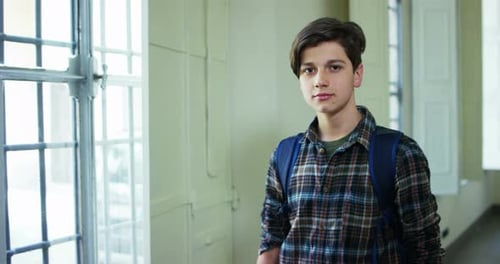 young nice boy looking to the camera in soft slow motion, school concept and learning language.