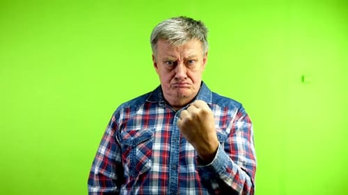 Man Clenches Fist Angrily on Green Screen