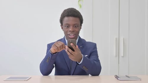 Young Adult Celebrates Success on Mobile Device