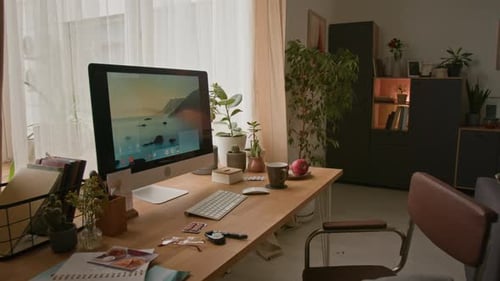 Cozy Home Office with Wooden Desk, Computer and Comfortable Chair