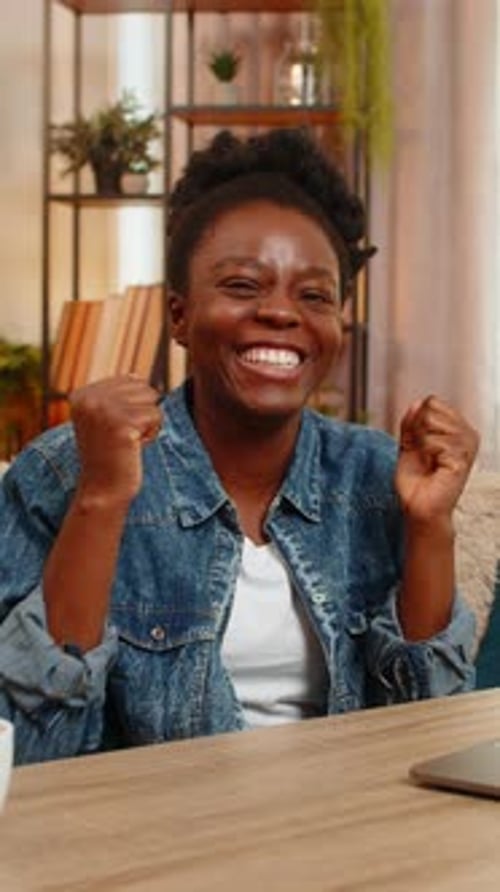Woman Works on Laptop, Cheering, Gives Two Thumbs Up