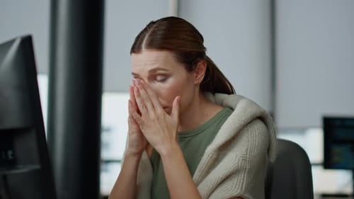 Woman Working at Computer, Tired in Modern Office