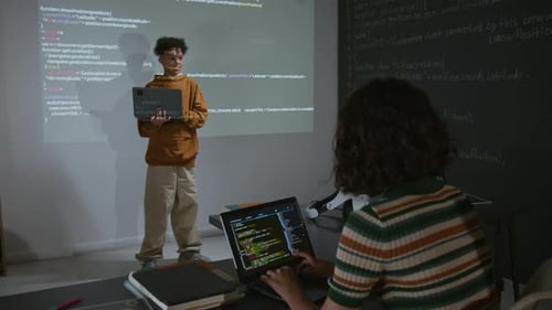 African American Boy Presenting Computer Script Projected on Screen