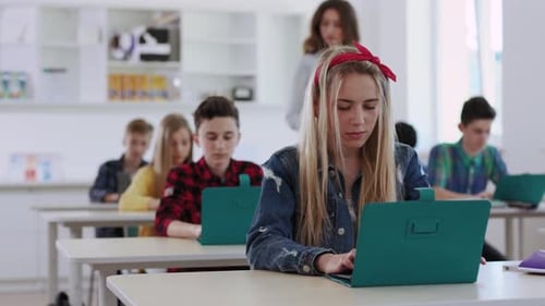 An Engaging and Diverse Classroom Scene Featuring Students Actively Using Their Laptops