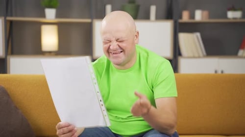 Man on Couch Relieved by Document