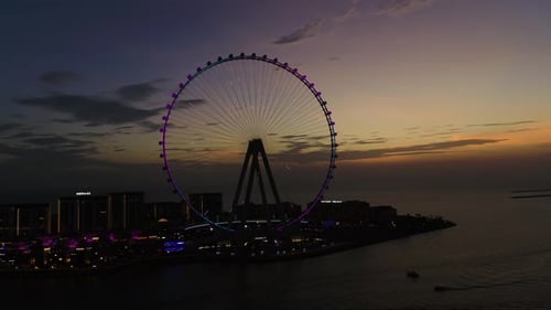 Aerial view of Ain Dubai Ferris wheel and skyline at dusk, UAE.