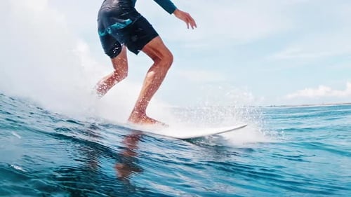 Surfer rides the ocean wave in tropical Maldives