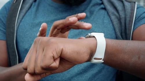 Close Up Male Athlete Hands Using Smartwatch Outdoors. Afro Jogger Checking Results