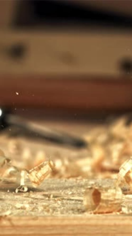 A Carpenter is Working on a Wooden Surface with a Plane Filmed on a Highspeed Camera at 1000 Fps