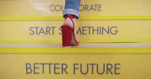 Woman Climbing Stairs in Blue Jeans and High Heels