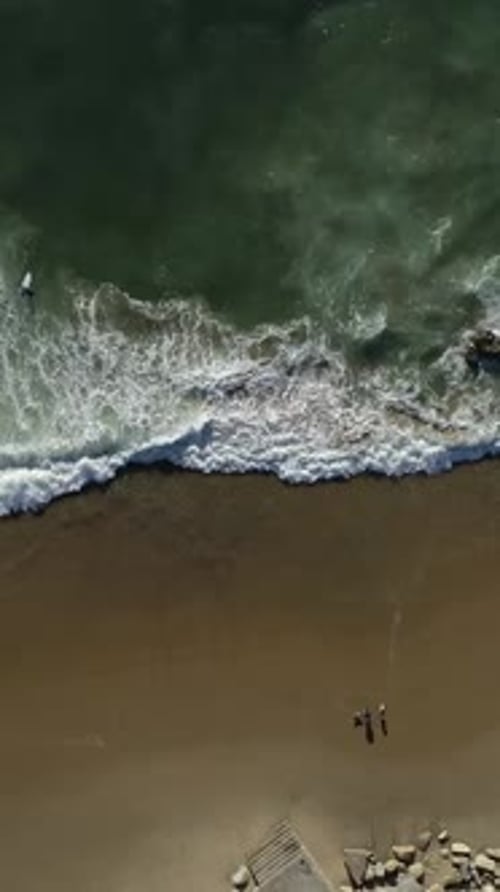 Vertical Video of Ocean Waves Rolling On Shoreline