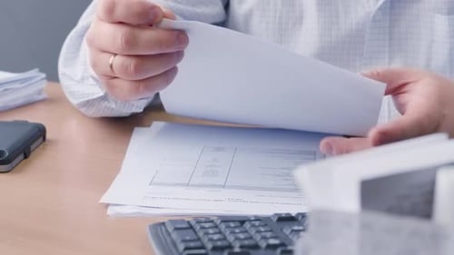 Accountant Reviewing Financial Documents at Office Desk