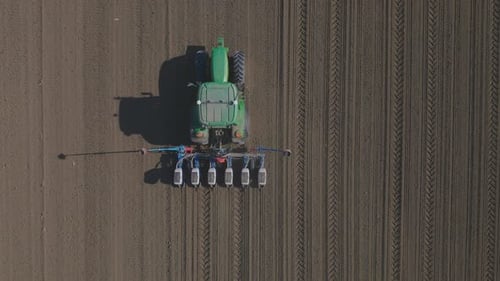 Aerial View of Tractor Working in Rural Field