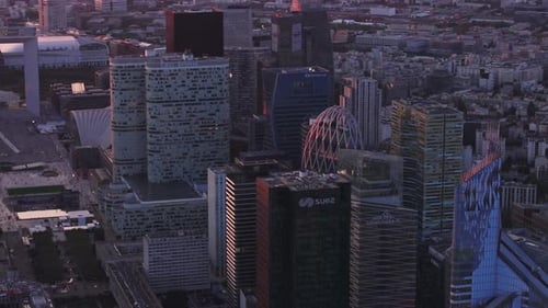 Aerial Slide and Pan Footage of Futuristic Buildings in Modern Business District at Dusk Financial