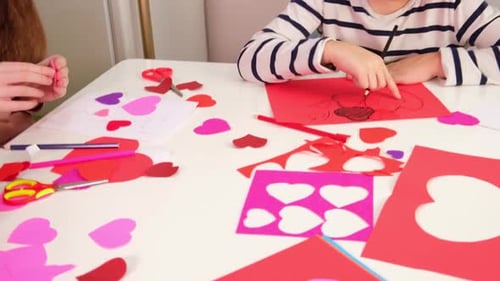 Valentines Day Kids Crafts Paper Heart Tracing and Cutting Out Hearts From Pink Paper for Valentines