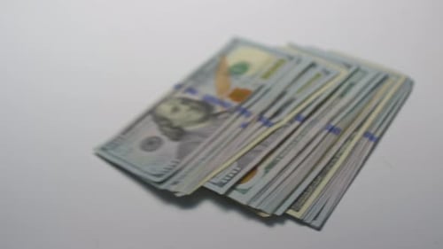 Several Thousand American Dollars Fall on the Table 100 Banknotes