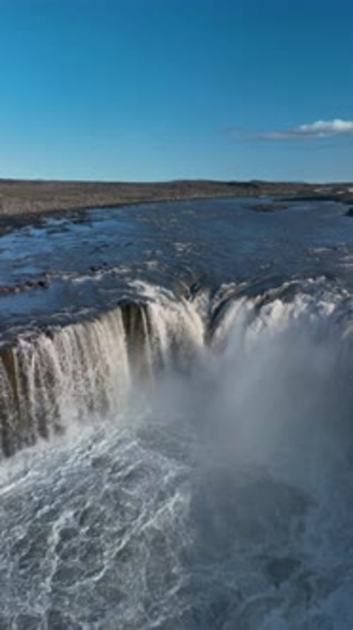 Aerial View of Scenic Waterfall Under Blue Sky