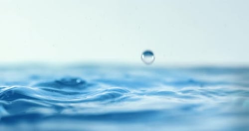 Water Drops Creating Ripples on Water Surface