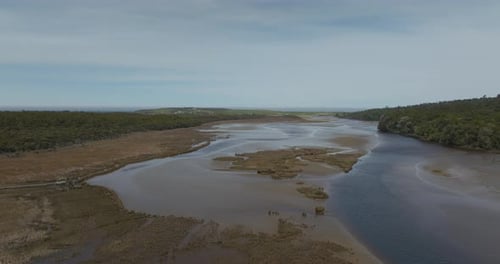 Tautuku river Estuary with brown brackish water in New Zealand ecotone, aerial