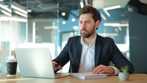 Focused Professional Working in Modern Office Environment