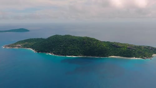 Aerial View of Lush Green Island Surrounded By Turquoise Waters