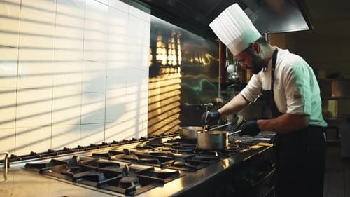 Chef Cooking in Commercial Kitchen at Restaurant