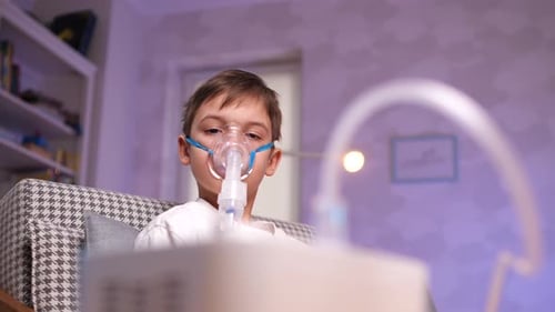 Child with Breathing Mask Using Nebulizer at Home