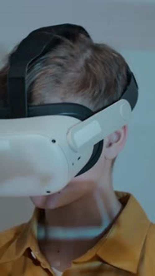 Face of Teenage Boy Playing Virtual Reality Game Wearing VR Headset