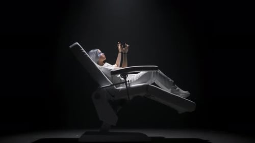 Woman in Futuristic Chair Using Augmented Reality Device