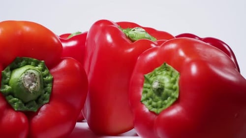 Red paprika rotating on a white background. Red fresh pepper. Close-up. High quality 4k footage