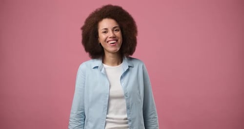 Smiling Attractive African American Woman Standing Over Pink Studio Background