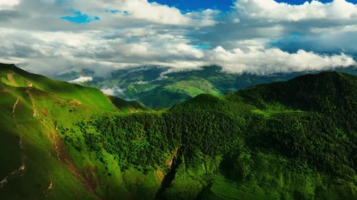 Lush Green Mountains Under a Sky with Floating Clouds Verdant Mountain Range with Clouds