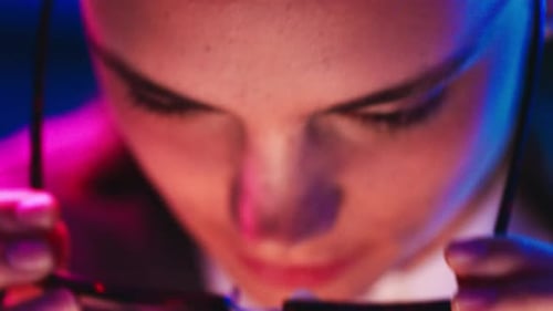Stylish Woman Puts on Glasses, Close Up Studio Lighting