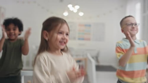 Happy Children Clapping Hands Together Indoors
