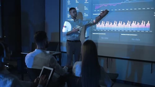 Young Adult Man Giving Data Presentation in Office