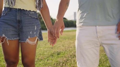 Couple Holding Hands in Urban Park