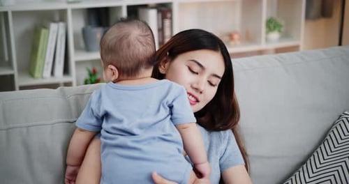 Loving Mother Holding Her Adorable Infant
