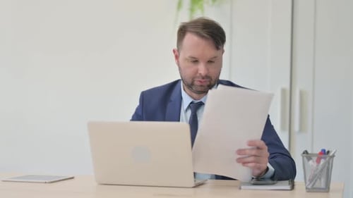 Frustrated Businessman Working in Office
