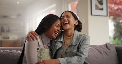 Friends, hug and couch with laughing, funny and joke in a home with bonding and love
