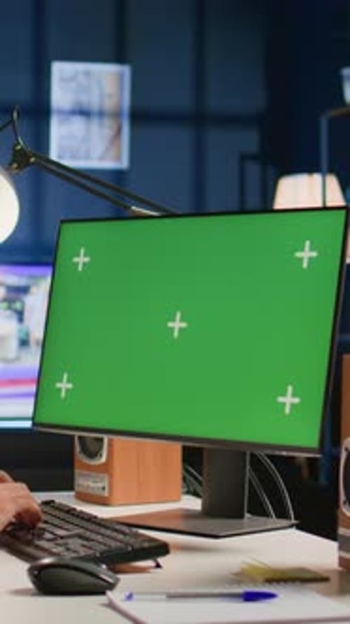 Vertikaler Videomann schaut auf den Chroma Key-Computerbildschirm