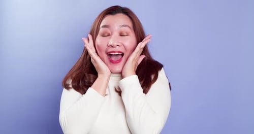 Portrait of young Asian lady with a positive expression, joyful surprise funky and looking at camera