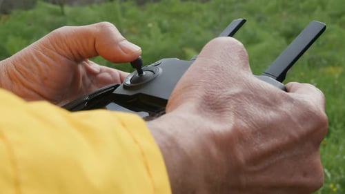 Hands Operating Drone Controller in Outdoor Setting