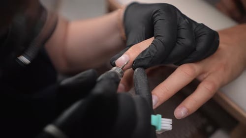Manicurist Files Nail with Electric File Close Up