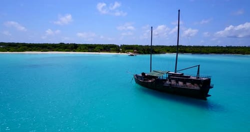a touristic boat anchored at the shores of a tropical island