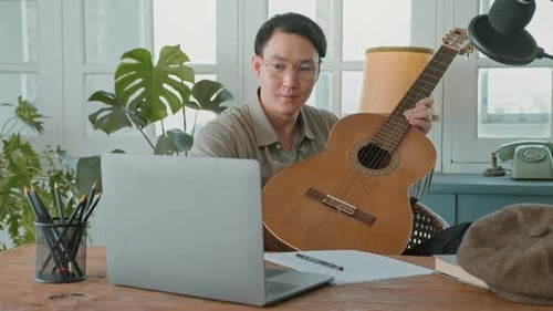 A musician is writing song in home Studio