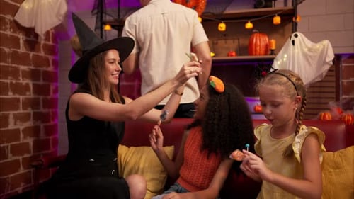 Family Celebrates Halloween with Candy and Costumes