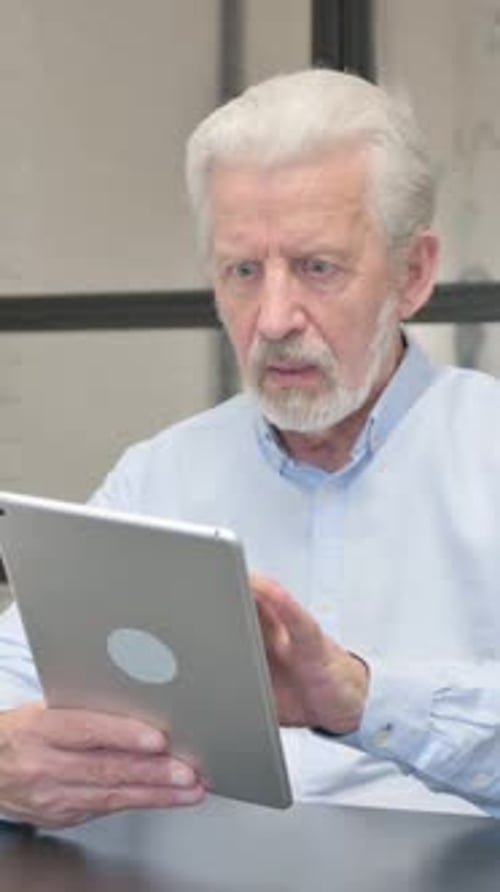 Senior Businessman with Loss on Tablet in Office