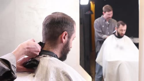 Man getting haircut at barber shop indoors